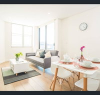 Gorgeous modern brand new two bedroom apartment with large lounge and private garden view balcony - Getaway Accommodation